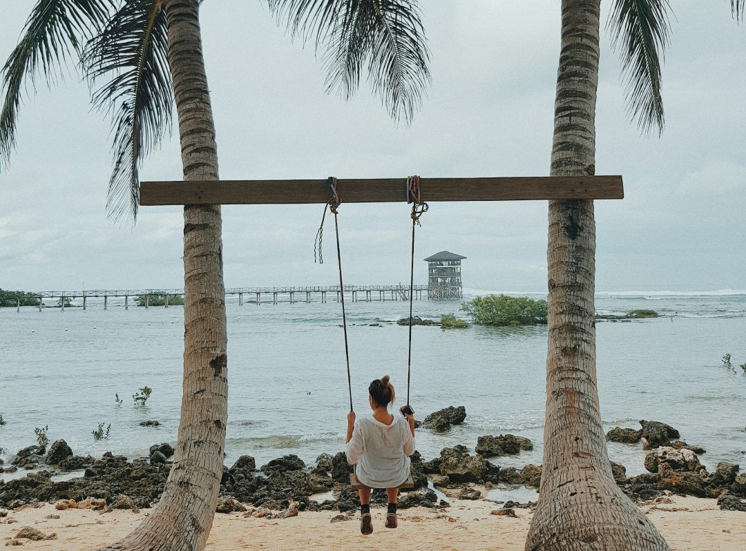 Unknown person sitting on swing