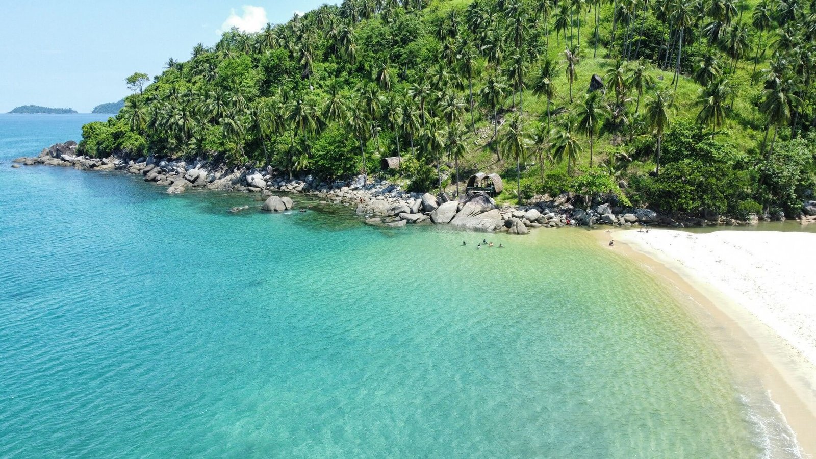 Turquoise water and forested hills at Alimanguan Beach, San Vicente, Palawan