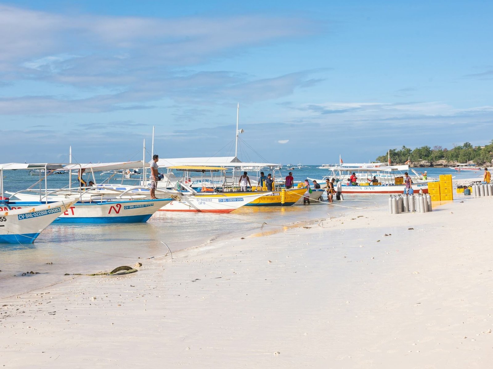 Bangka boats lined up on the white sand of Alona Beach, Panglao, Bohol