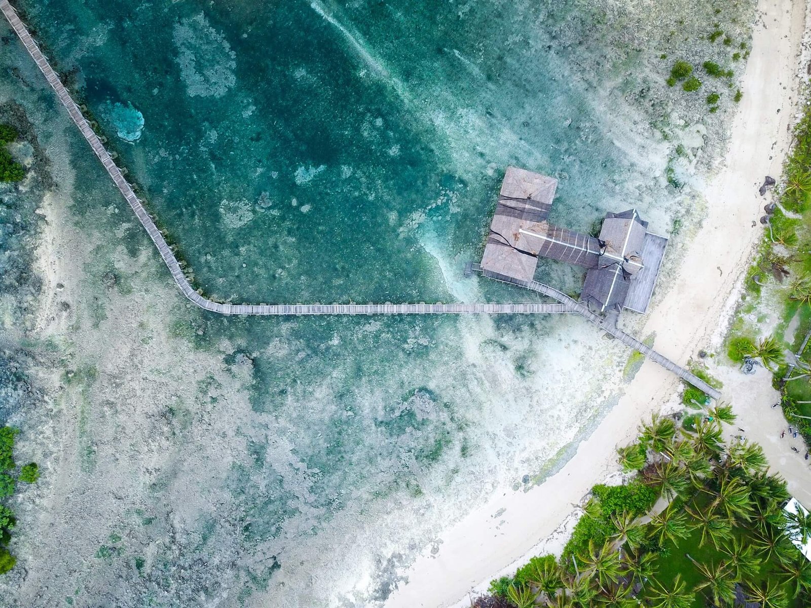 Aerial view of the Cloud 9 boardwalk running from the beach out over the reef in Siargao