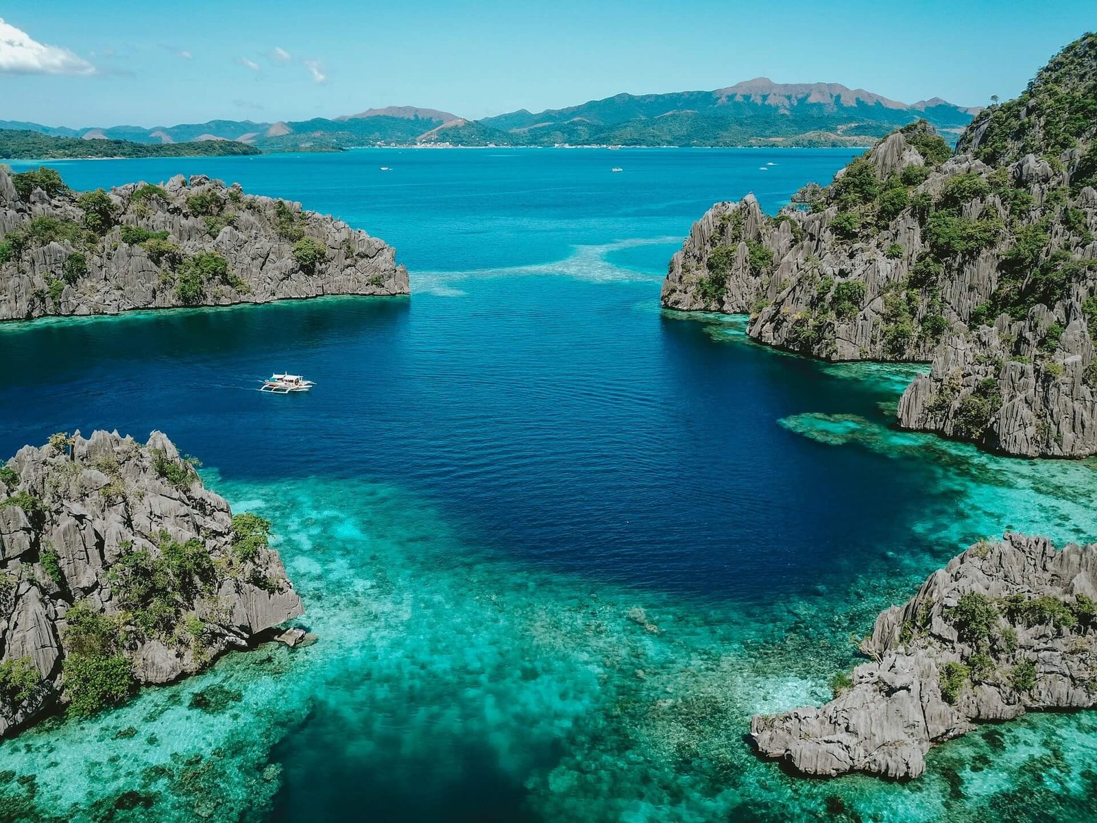 Aerial view of a turquoise lagoon between limestone islands in Coron, Palawan
