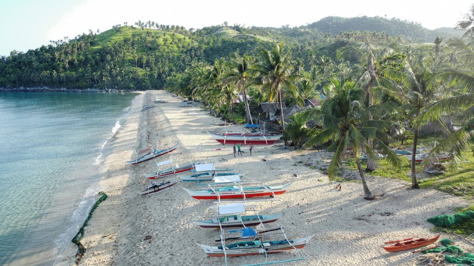 Bangka boats on the sandy shore of Irawan Beach, San Vicente, Palawan