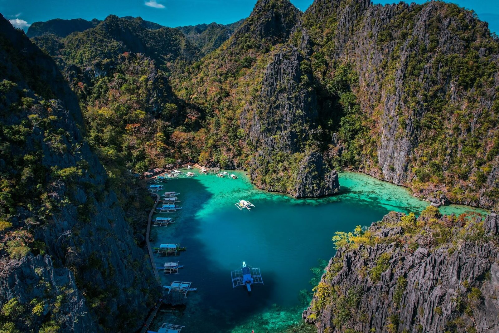 Boats in the blue cove below the Kayangan Lake viewpoint in Coron, Palawan