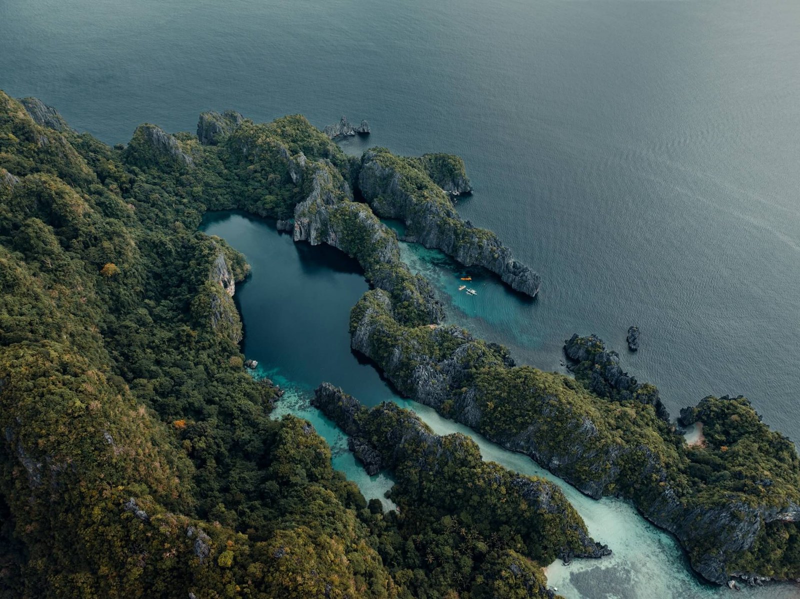 Jagged limestone islands covered in green forest in Palawan, Philippines