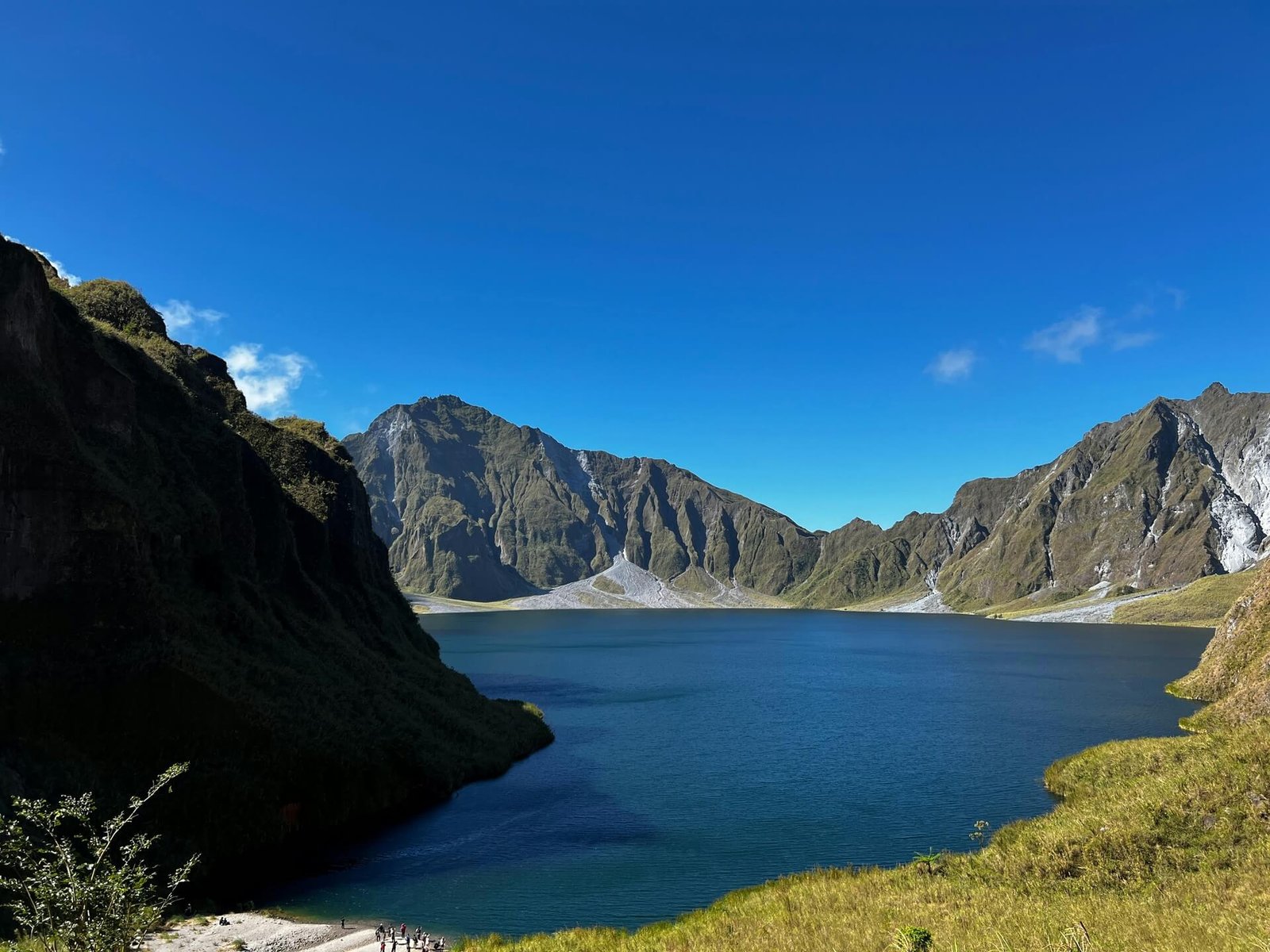Deep blue Mt Pinatubo crater lake ringed by steep caldera walls