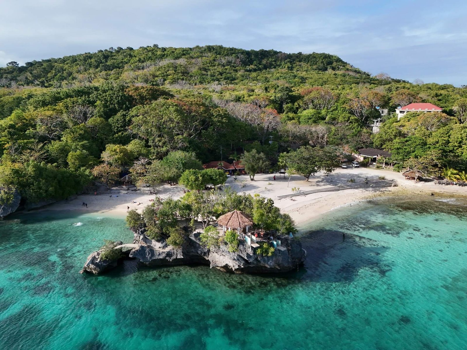 Rocky islet and turquoise water at Salagdoong Beach, Maria, Siquijor