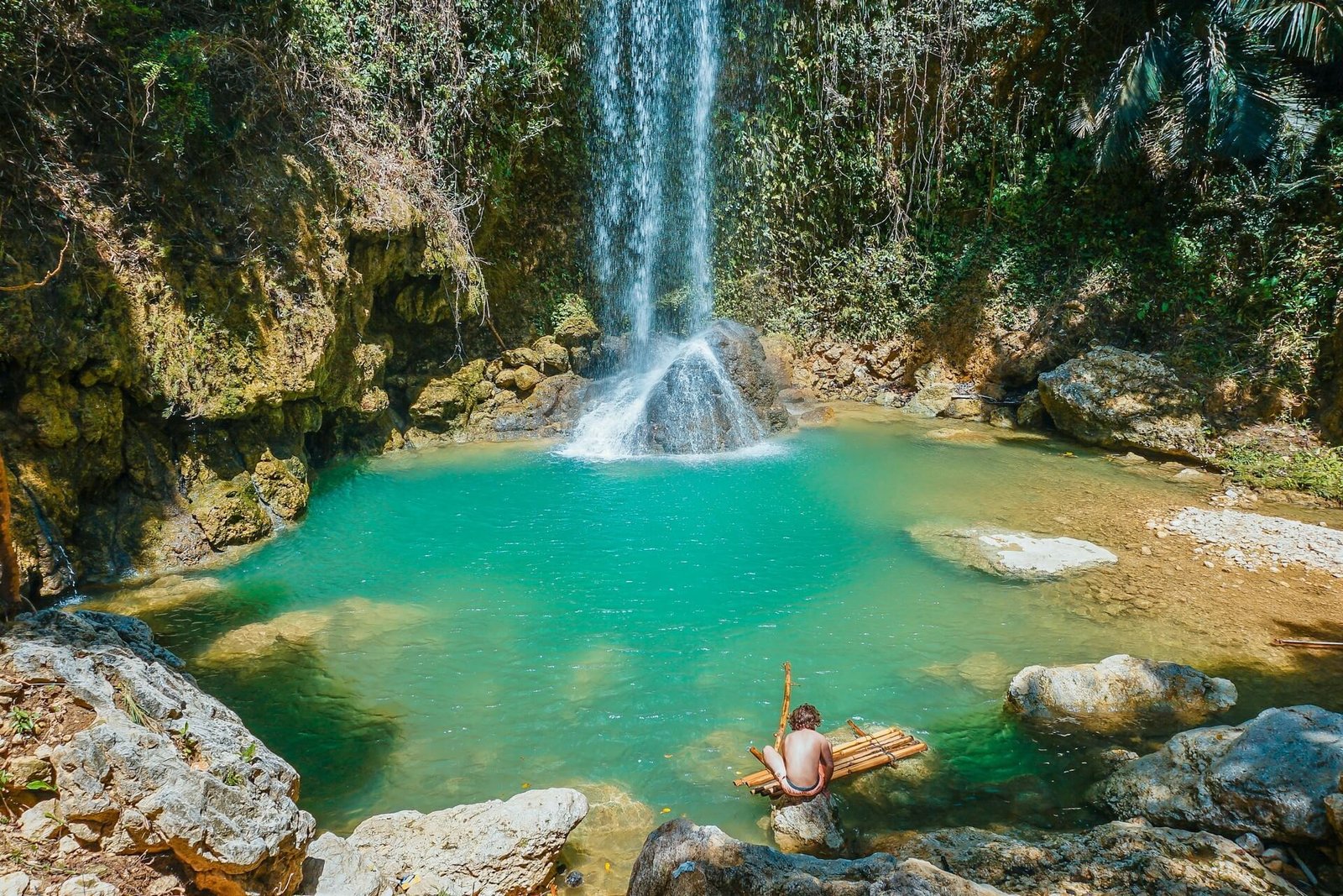 Waterfall pouring into a turquoise pool in the jungle near Badian, Cebu